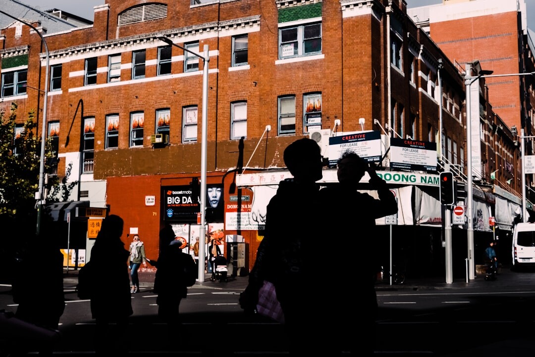 Camera crew filming a reportage outdoors in an urban street