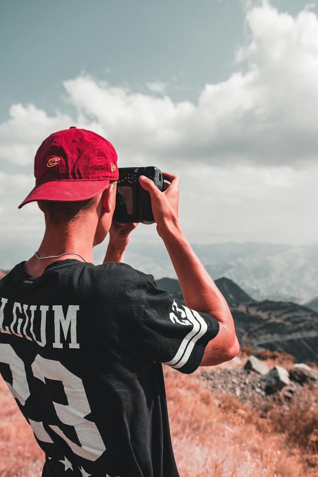 Belgian videographer holding a professional camera on his shoulder
